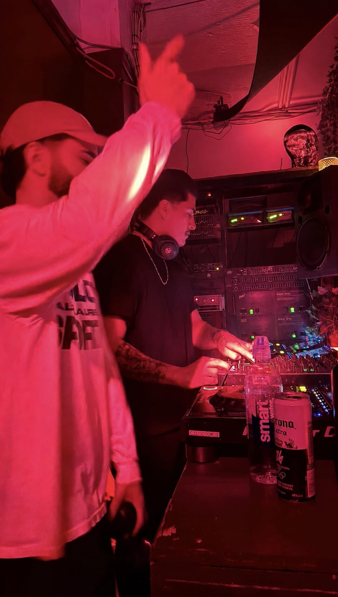 Niko Couture playing back-to-back in a red-lit booth in Montréal